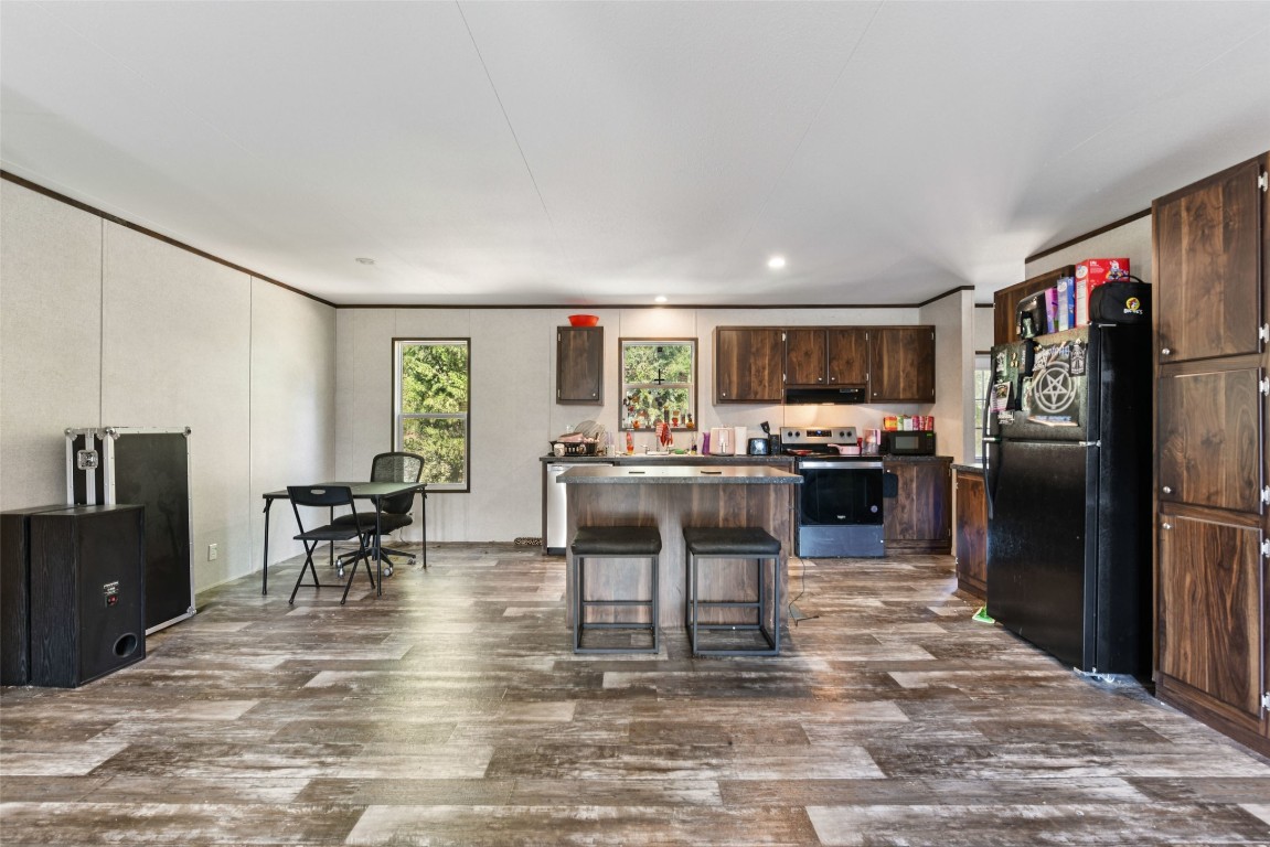 144 Los Arcos Road Elgin, TX 78621 - Photo 5 of 11 a living room with stainless steel appliances kitchen island granite countertop furniture and a kitchen view
