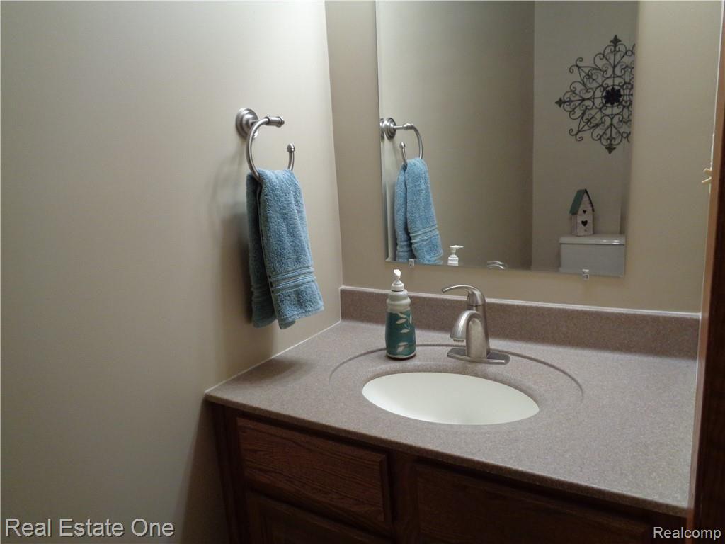 9590 Ridge Top Trail Clarkston, MI 48348 - Photo 60 of 80 Entry level Lav situated off laundry and mud room. Also new counter, faucet, fixture, etc!!!