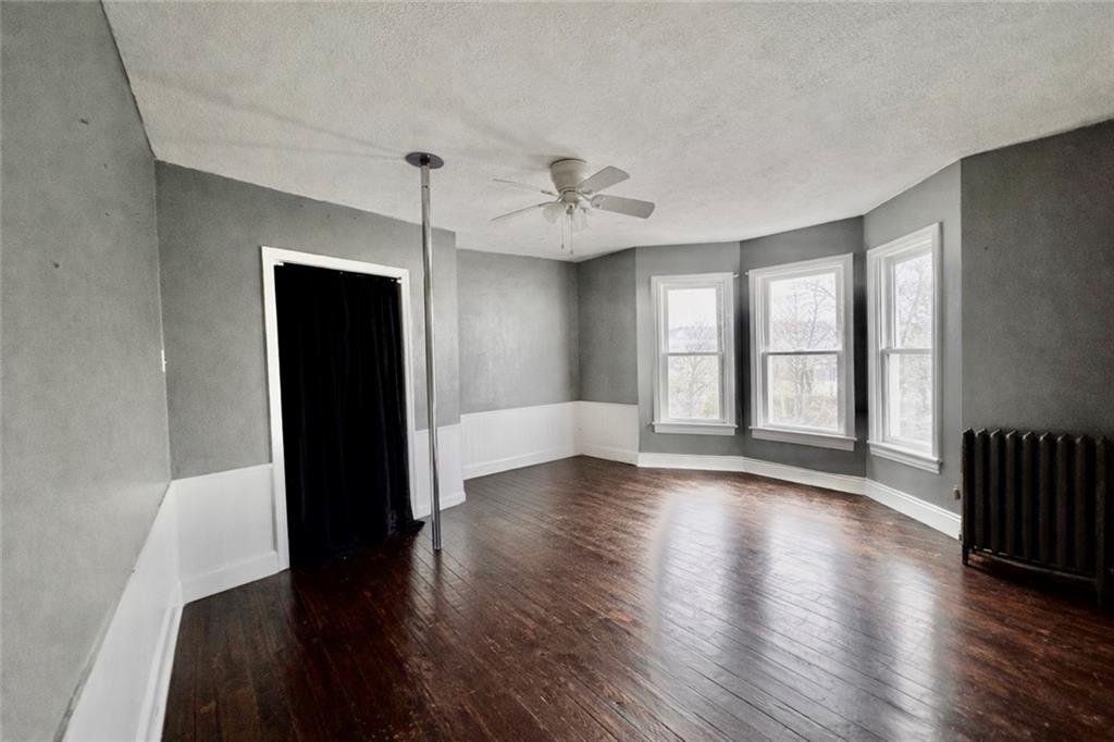 1409 Cambria Avenue Windber, PA 15963 - Photo 13 of 19 a view of an empty room with wooden floor and a window