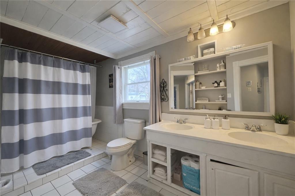 1409 Cambria Avenue Windber, PA 15963 - Photo 14 of 19 a spacious bathroom with a sink a toilet a mirror and shower