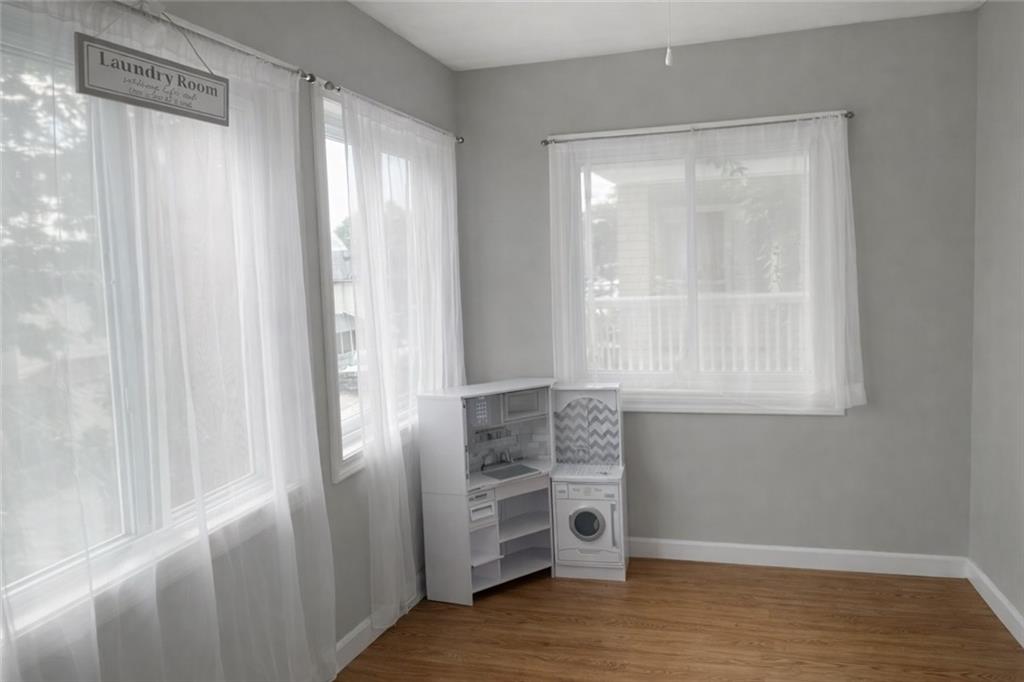 1409 Cambria Avenue Windber, PA 15963 - Photo 4 of 19 a view of an empty room with wooden floor and a window