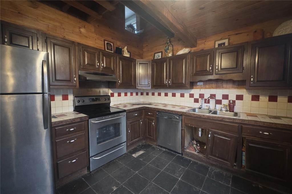 1409 Cambria Avenue Windber, PA 15963 - Photo 7 of 19 a kitchen with stainless steel appliances granite countertop a refrigerator a sink dishwasher a stove and a refrigerator