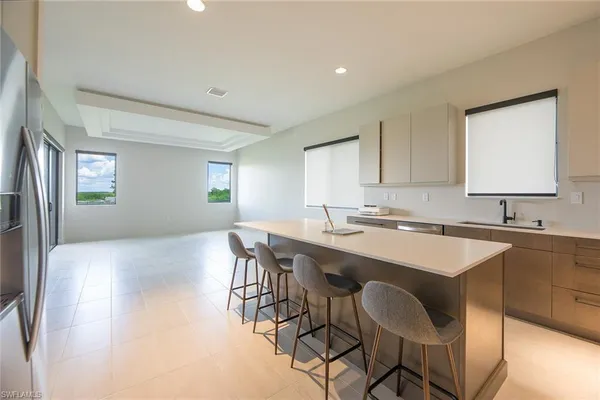 a kitchen with a table chairs sink and cabinets