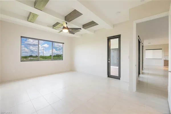 an empty room with fan and windows