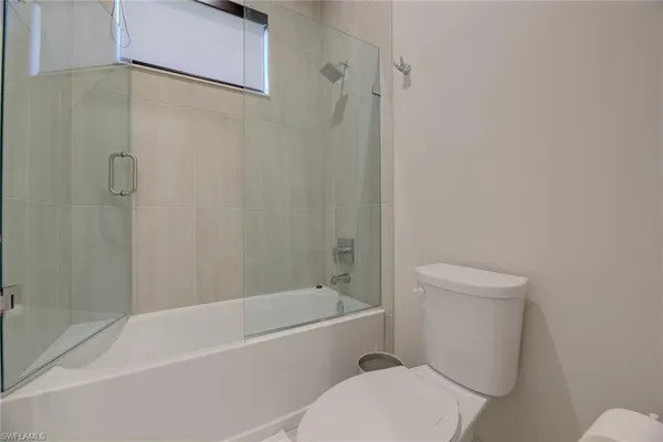 a white toilet and tub sitting next to a bathroom sink