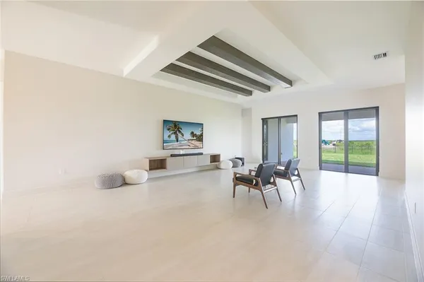 a dining room with furniture and a large window