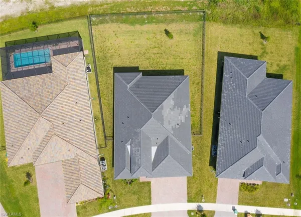 an aerial view of a house with a yard