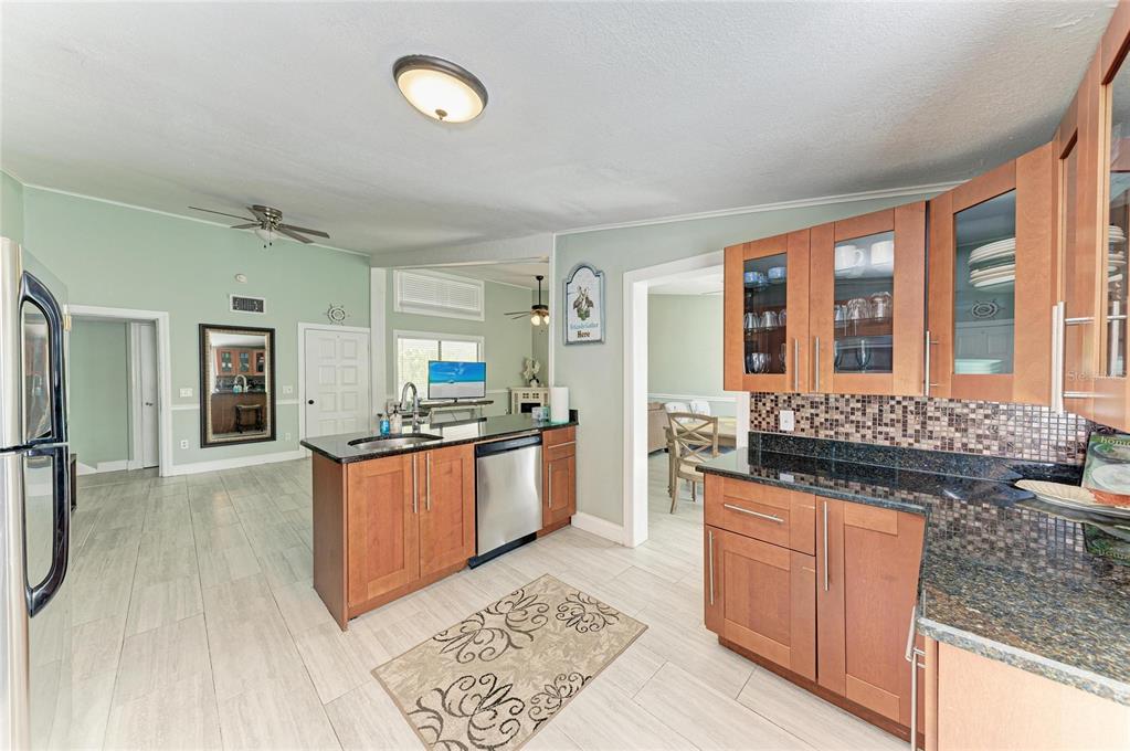 1581 Royal Road Venice, FL 34293 - Photo 16 of 41 a large kitchen with granite countertop a large stove a sink and a refrigerator