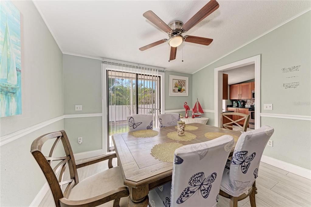 1581 Royal Road Venice, FL 34293 - Photo 18 of 41 a dining room with furniture a chandelier and wooden floor