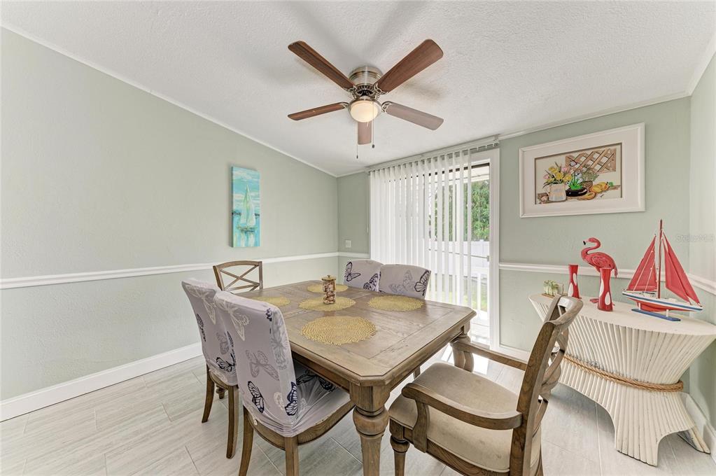 1581 Royal Road Venice, FL 34293 - Photo 19 of 41 a view of a dining room with furniture and a ceiling fan