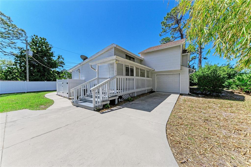 1581 Royal Road Venice, FL 34293 - Photo 2 of 41 a front view of a house with a yard and garage
