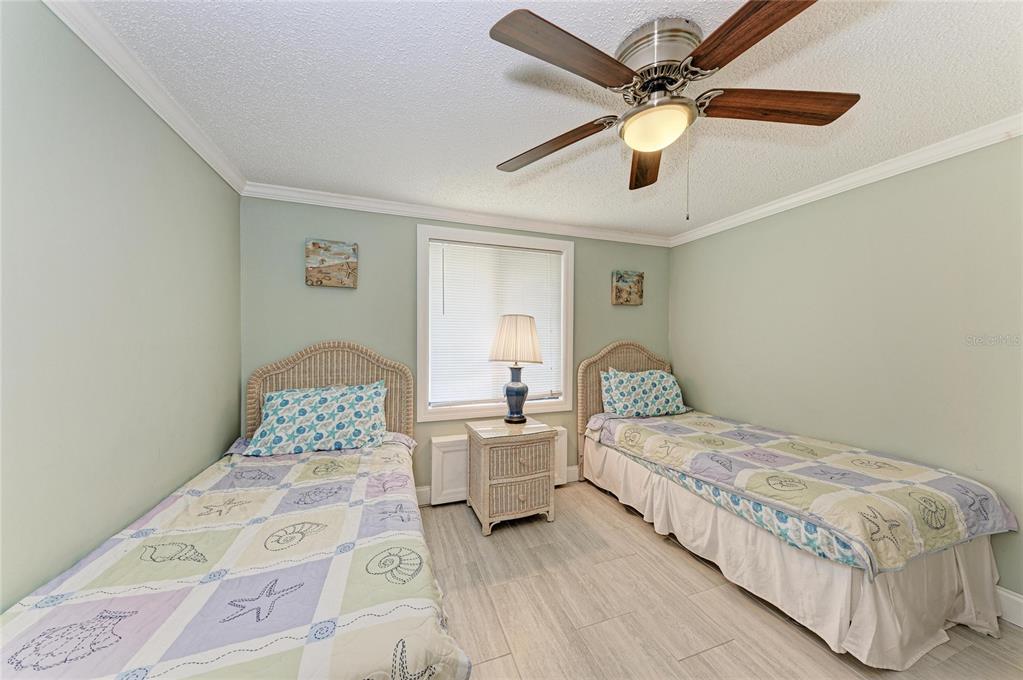 1581 Royal Road Venice, FL 34293 - Photo 27 of 41 a bedroom with a large bed and a chandelier