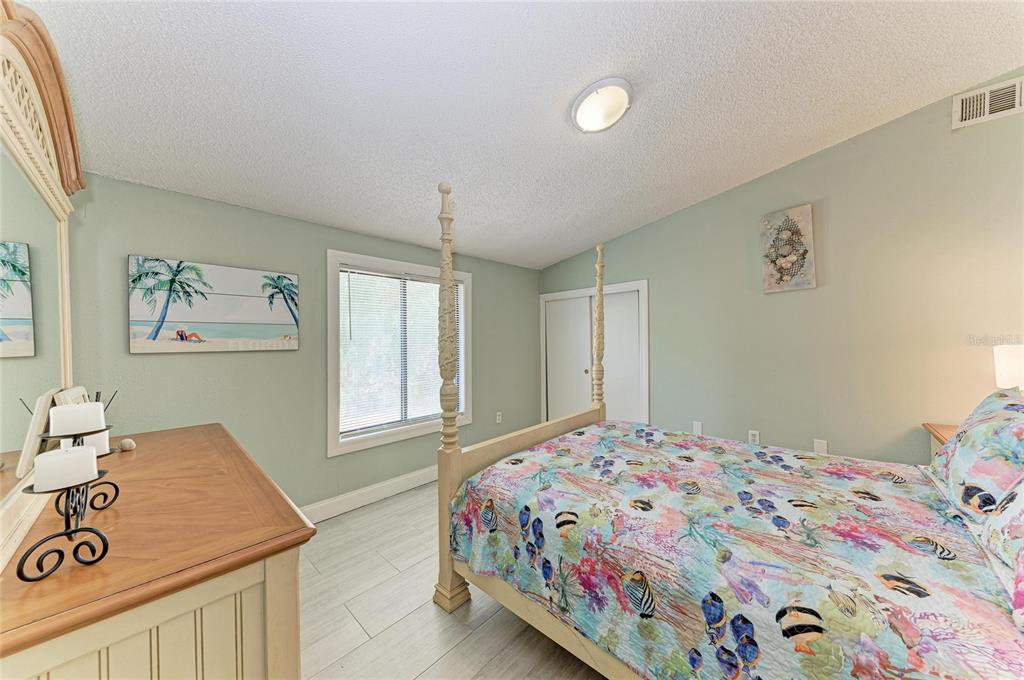 1581 Royal Road Venice, FL 34293 - Photo 29 of 41 a bedroom with a bed and a dresser in it