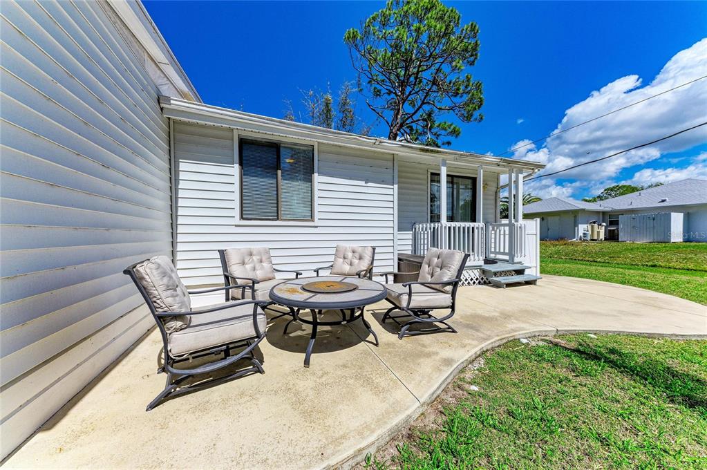 1581 Royal Road Venice, FL 34293 - Photo 36 of 41 a view of a patio with table and chairs with wooden fence