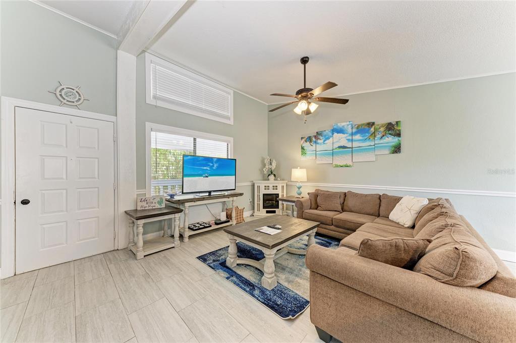 1581 Royal Road Venice, FL 34293 - Photo 9 of 41 a living room with furniture flat screen tv and a window