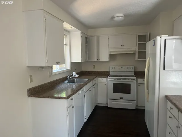a kitchen with a sink stove and refrigerator