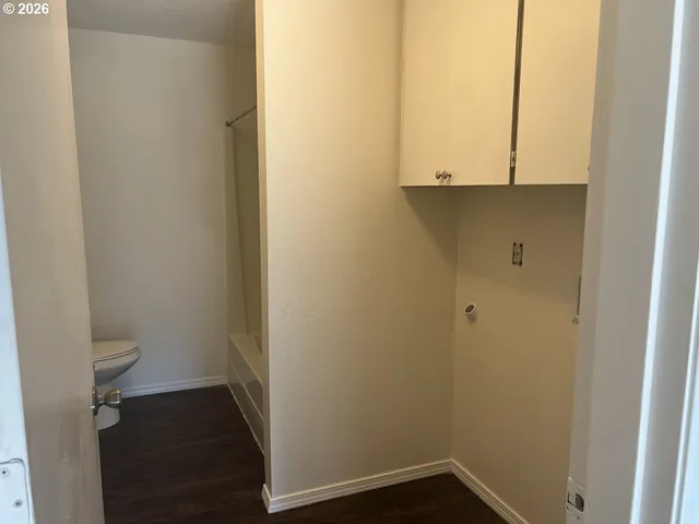 a white toilet sitting next to a white sink