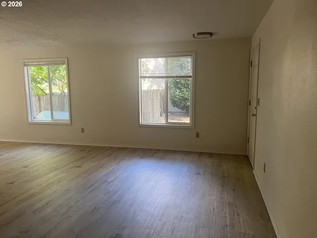 a view of room with wooden floor