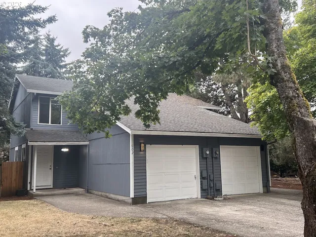 a house that has a tree in front of it