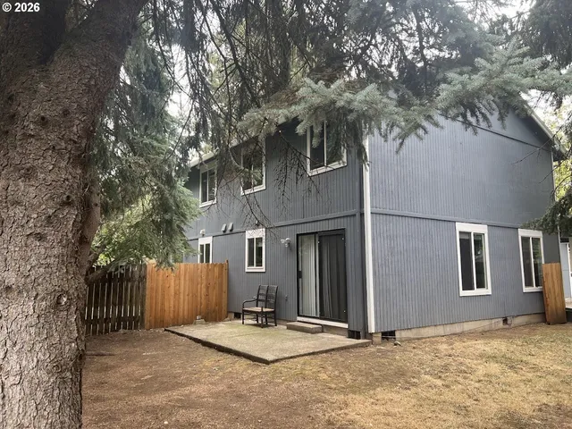 a view of backyard with large tree
