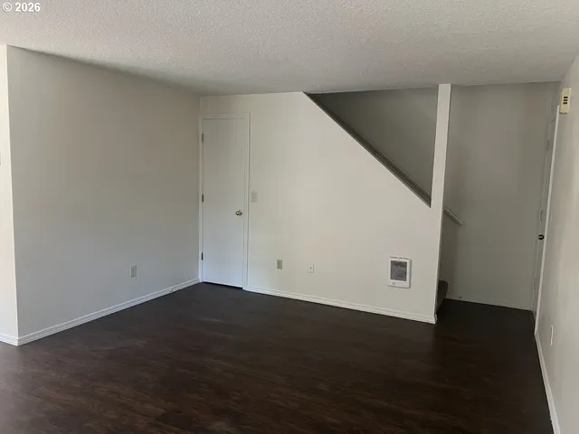 an empty room with wooden floor