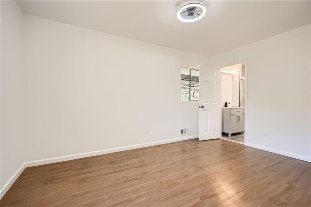 4201 Regal Ridge Road Austell, GA 30106 - Photo 14 of 21 an empty room with wooden floor and windows