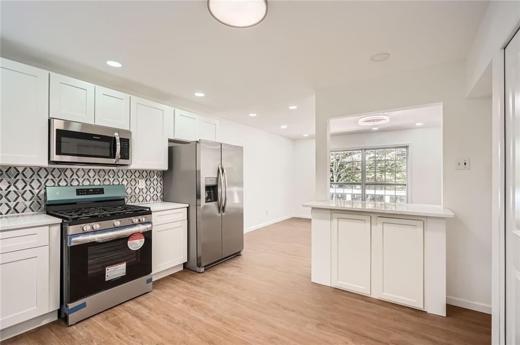 4201 Regal Ridge Road Austell, GA 30106 - Photo 3 of 21 a kitchen with a stove a sink and a microwave