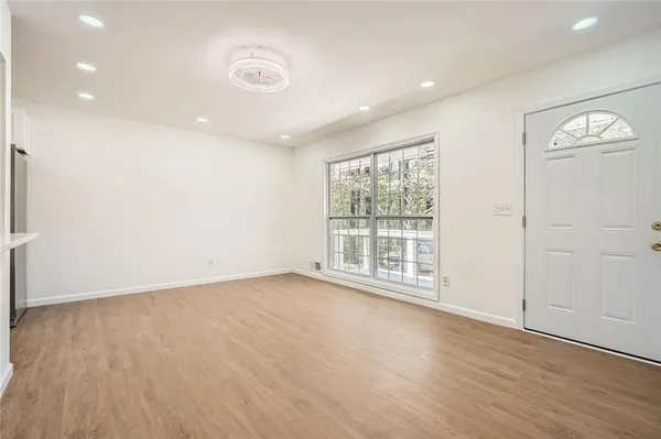 wooden floor in an empty room with a window