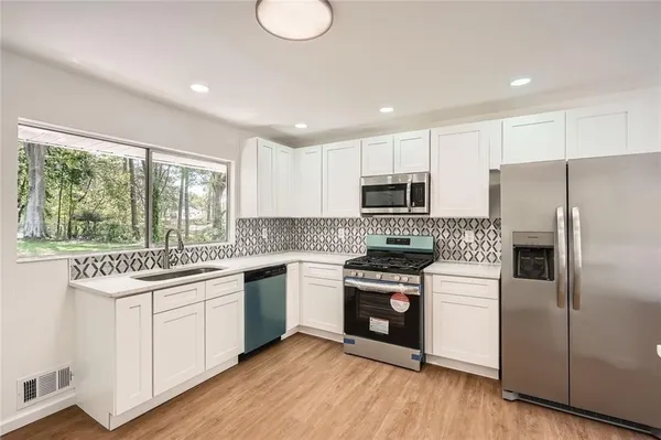 a kitchen with a sink stove and refrigerator