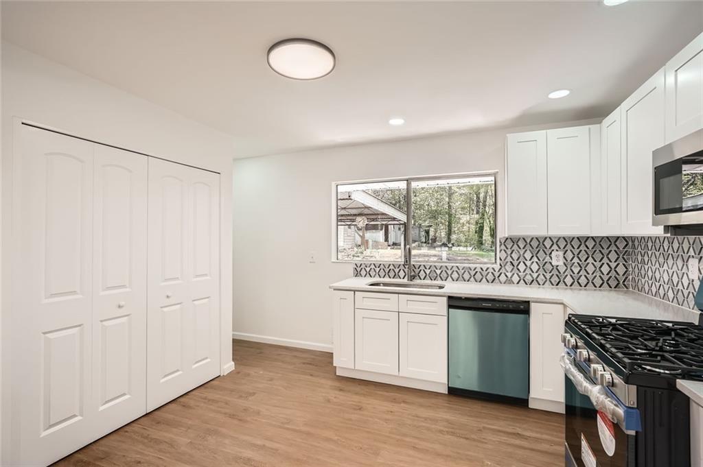 4201 Regal Ridge Road Austell, GA 30106 - Photo 9 of 21 a kitchen with white cabinets and appliances