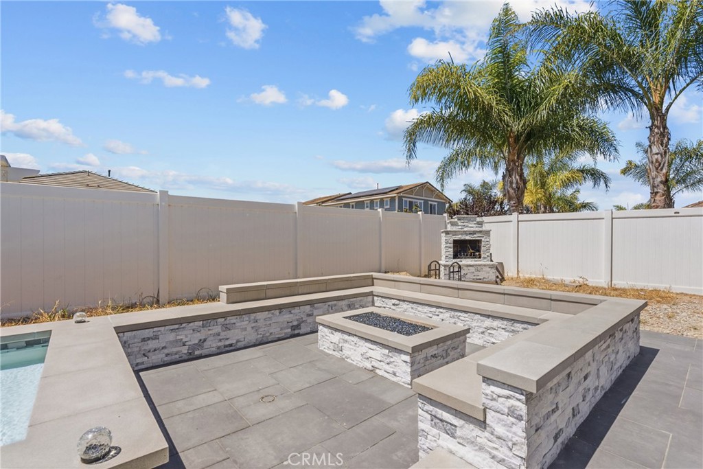 232 River Street Fillmore, CA 93015 - Photo 58 of 61 Exceptional outdoor entertaining space featuring a sparling poo, cozy firepit, ample seating areas, and a wood-burning-fireplace, perfect for or hosting gatherings year-round