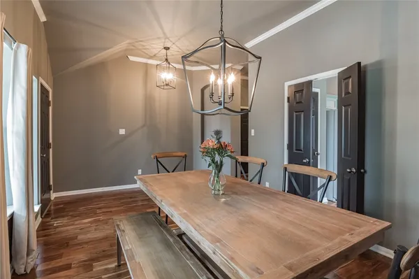 a dining room with table and chairs