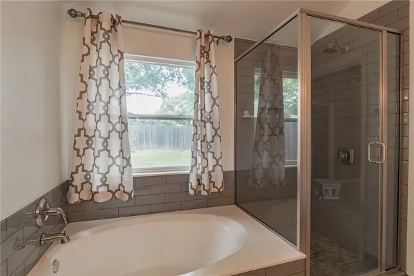 a bathroom with a bathtub and shower