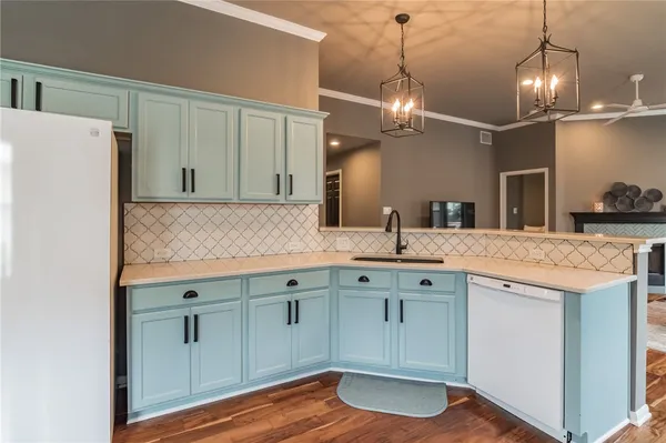 a kitchen with center island and wooden floor