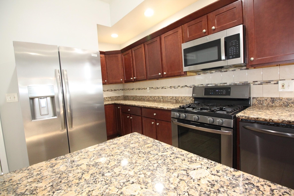83 Devon Street, Unit 1 Boston, MA 02121 - Photo 3 of 21 a kitchen with a stove microwave and refrigerator