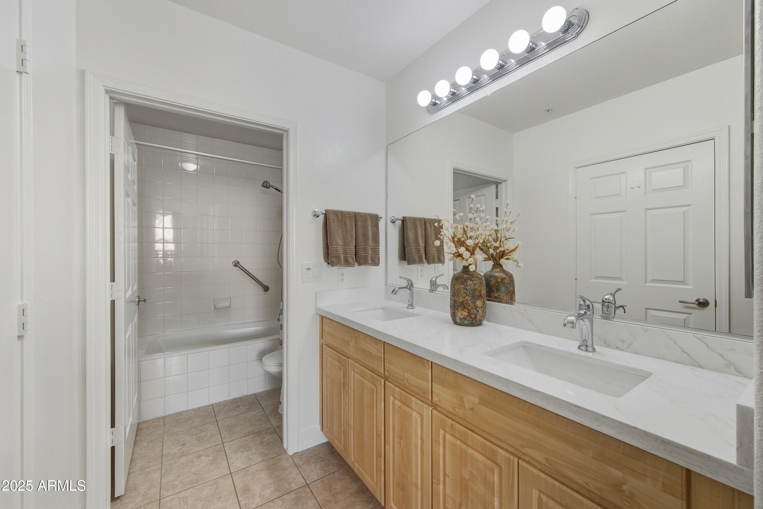 7575 East Indian Bend Road, Unit 1126 Scottsdale, AZ 85250 - Photo 13 of 33 a bathroom with a double vanity sink a mirror and a shower