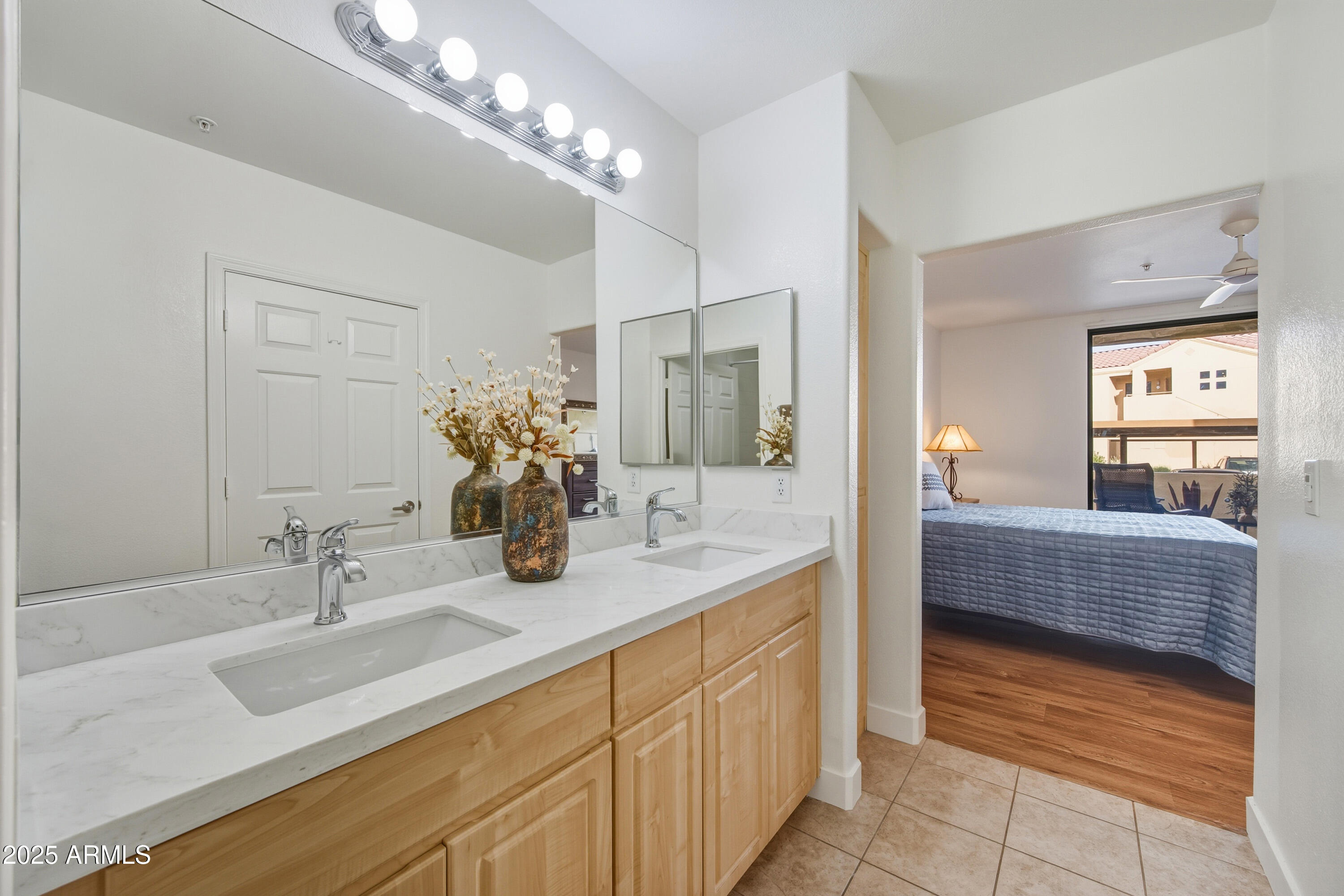 7575 East Indian Bend Road, Unit 1126 Scottsdale, AZ 85250 - Photo 16 of 33 a bathroom with double vanity sinks a large mirror and a shower