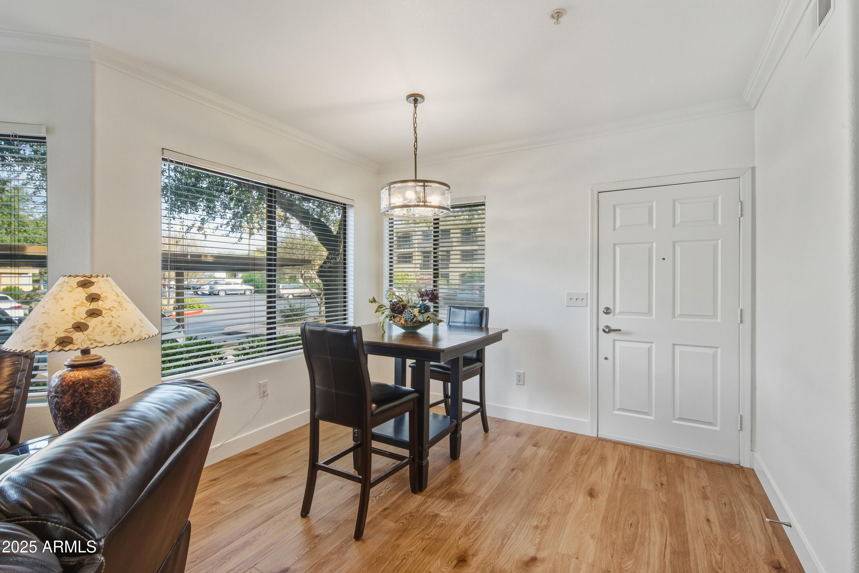 7575 East Indian Bend Road, Unit 1126 Scottsdale, AZ 85250 - Photo 3 of 33 a view of a dining room with furniture window and wooden floor