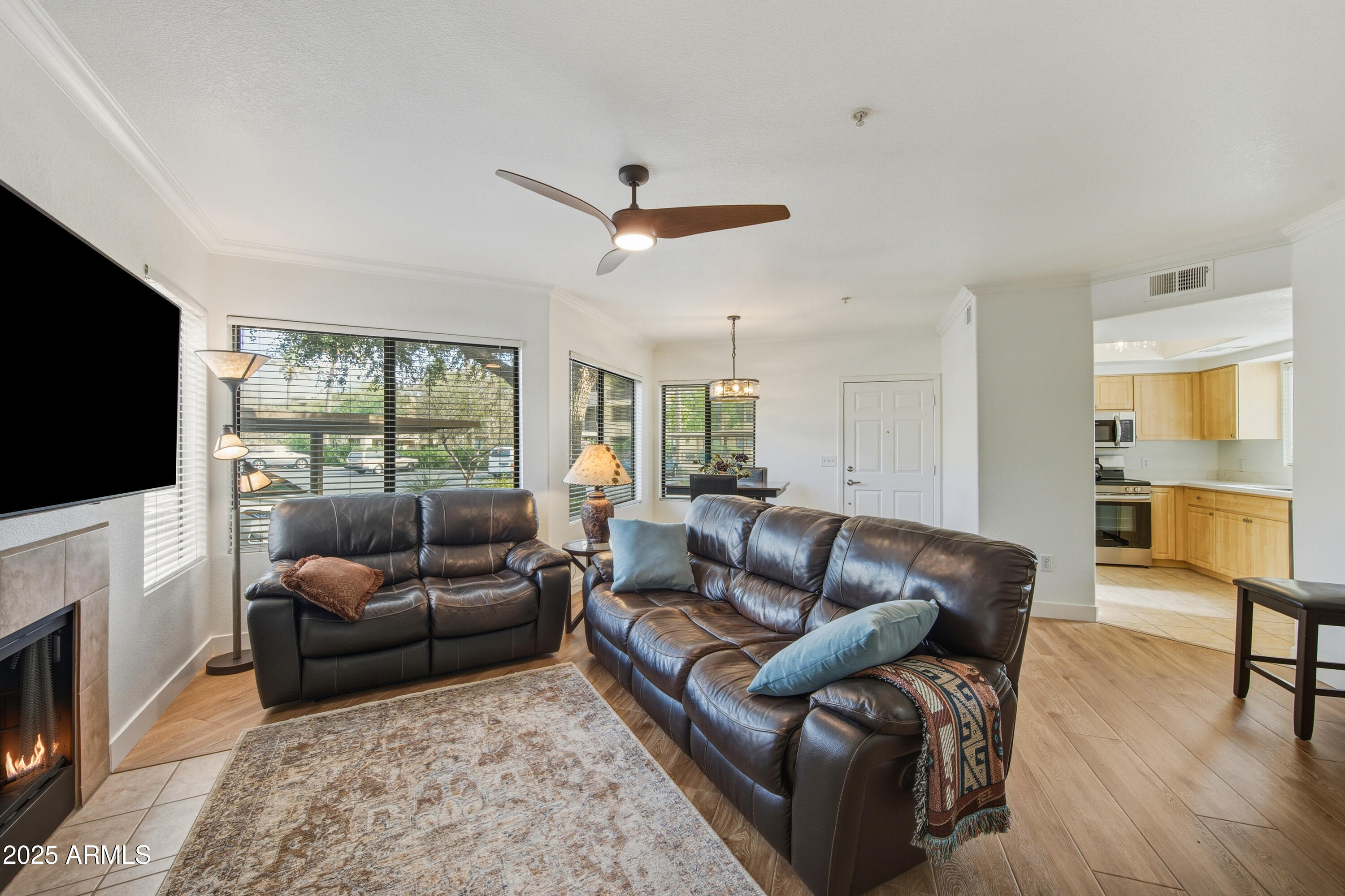 7575 East Indian Bend Road, Unit 1126 Scottsdale, AZ 85250 - Photo 5 of 33 a living room with furniture a flat screen tv and a fireplace
