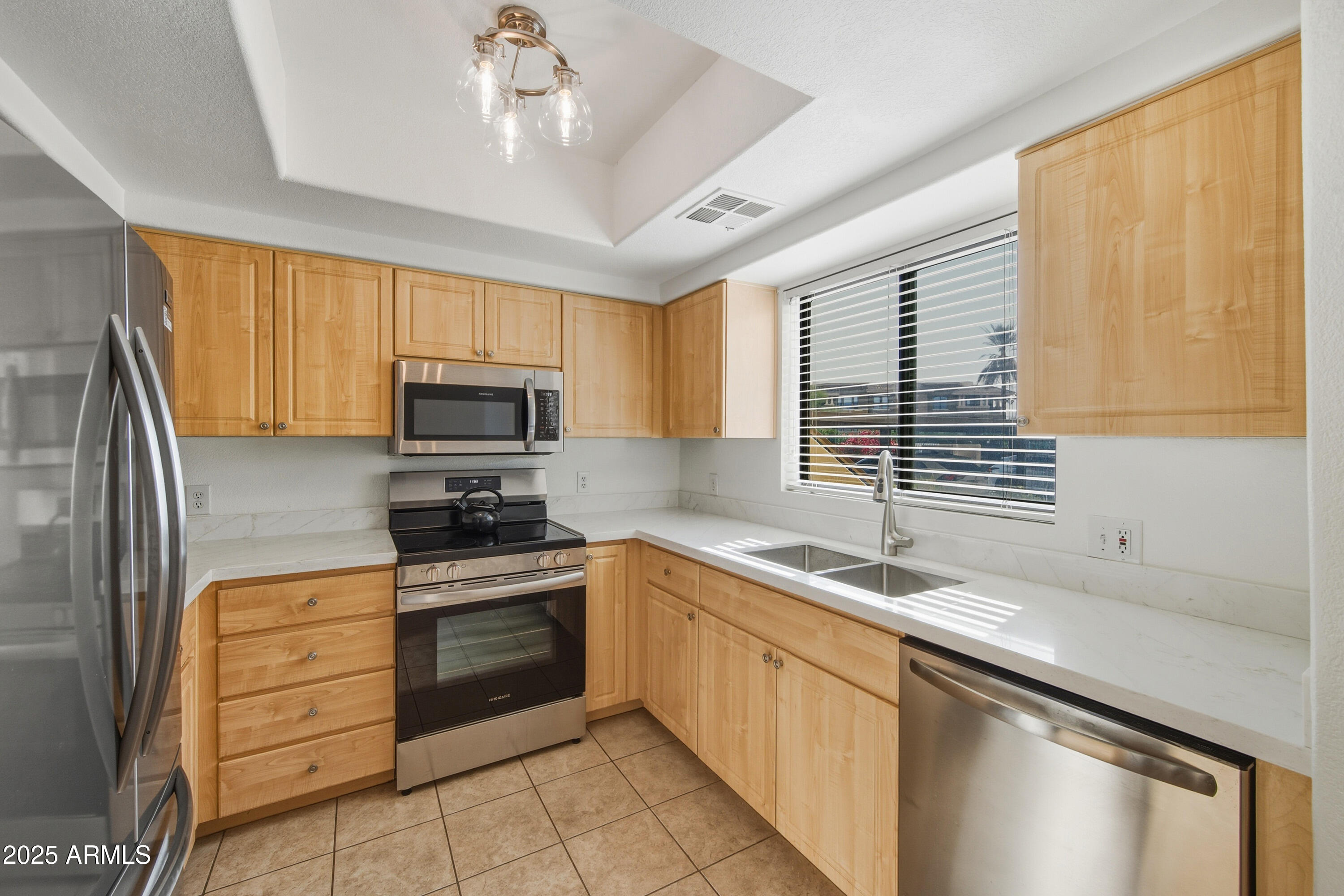 7575 East Indian Bend Road, Unit 1126 Scottsdale, AZ 85250 - Photo 7 of 33 a kitchen with granite countertop a sink stainless steel appliances and cabinets