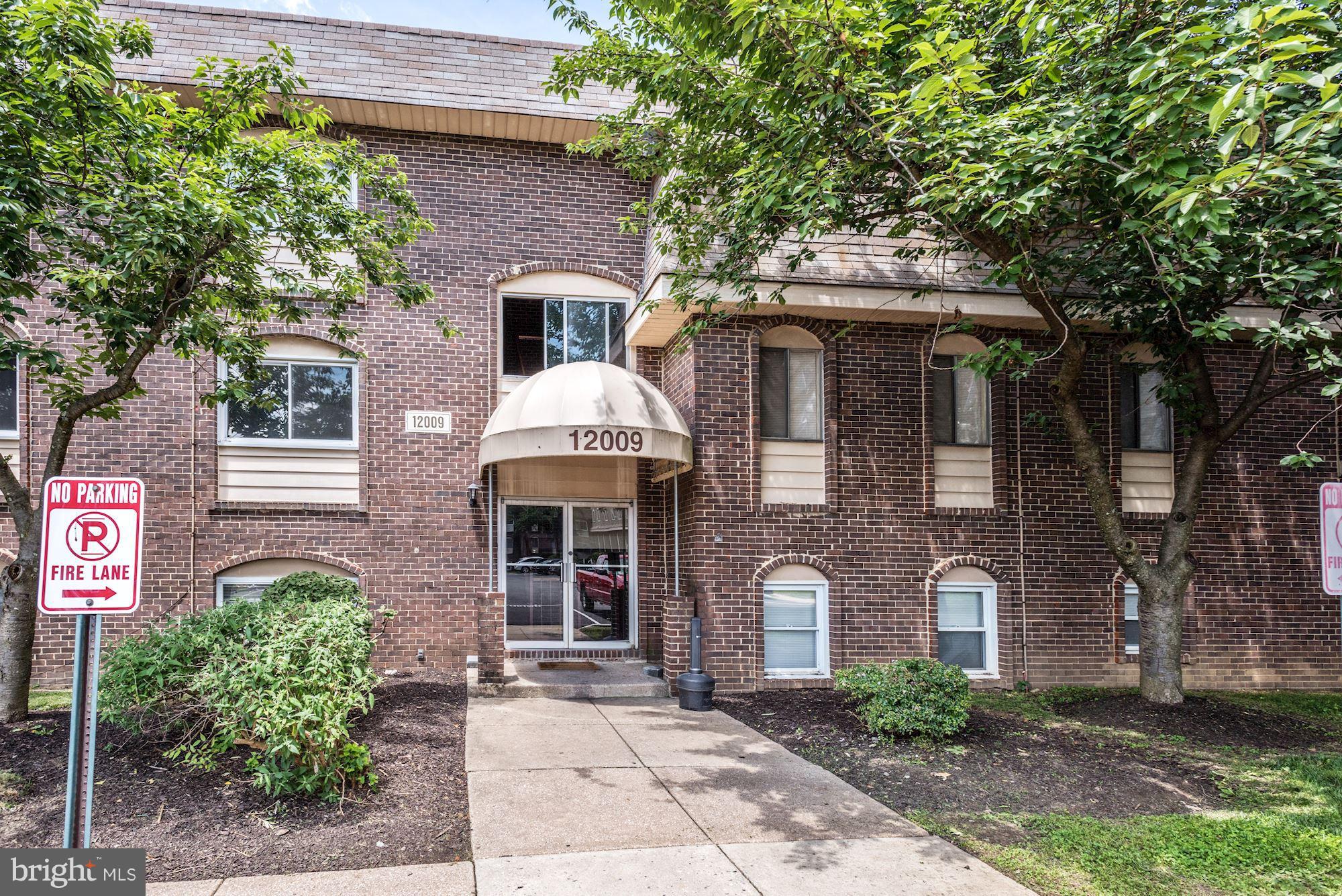 12009 Tarragon Road, Unit F Reisterstown, MD 21136 - Photo 1 of 22 a front view of a house with garden