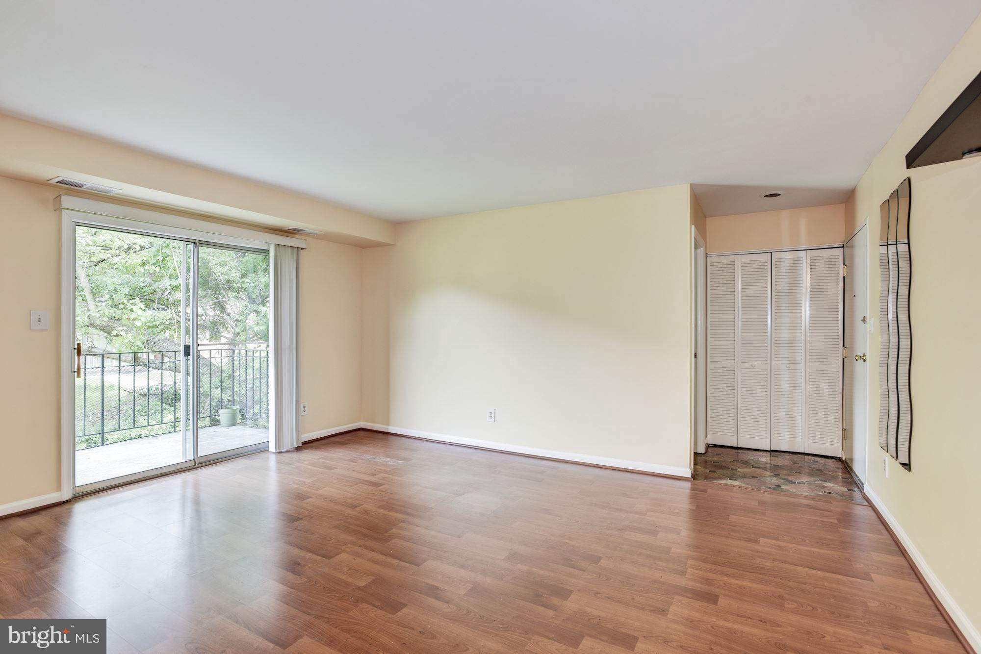 12009 Tarragon Road, Unit F Reisterstown, MD 21136 - Photo 2 of 22 a view of an empty room with wooden floor and a window