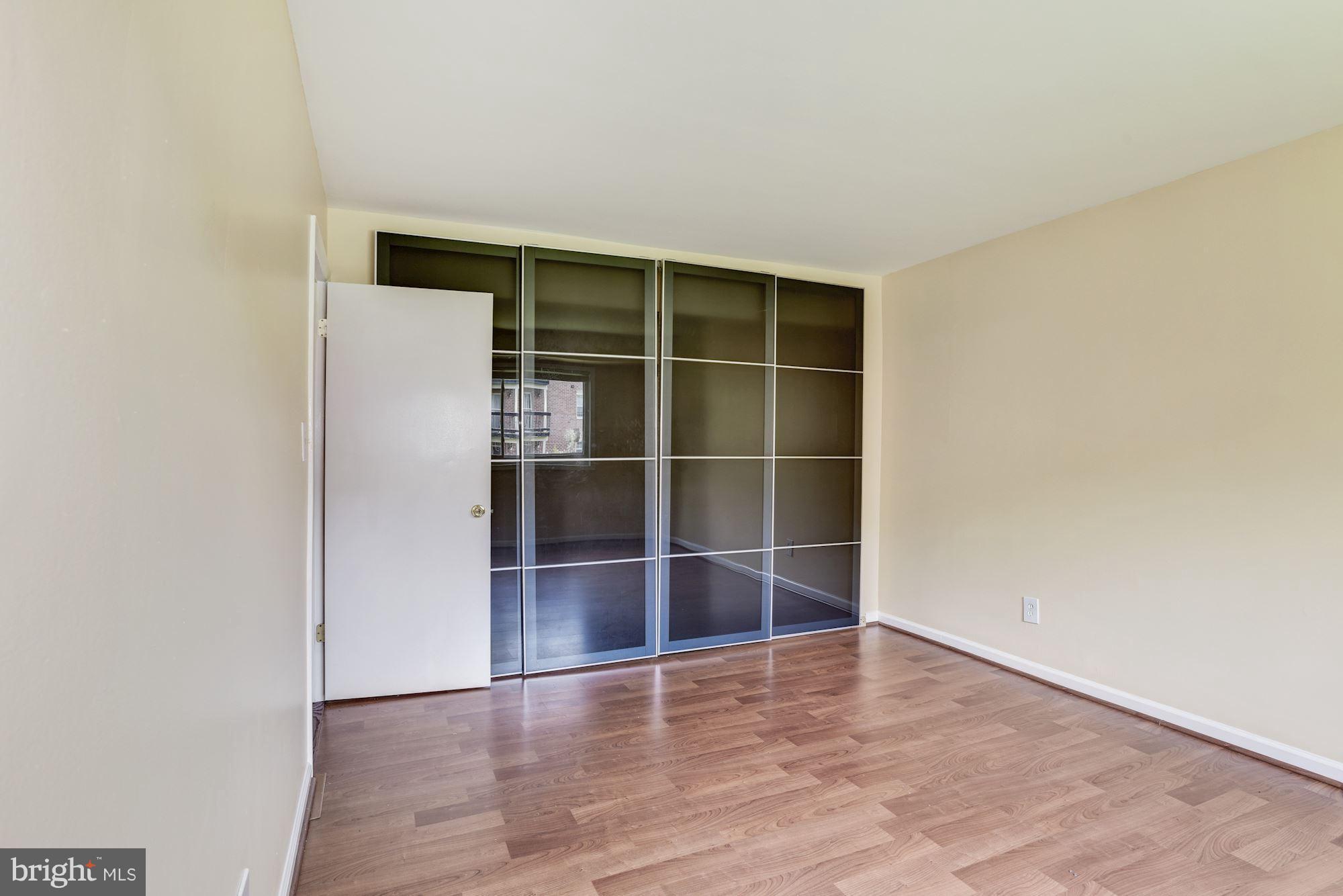 12009 Tarragon Road, Unit F Reisterstown, MD 21136 - Photo 12 of 22 a view of empty room with wooden floor and window