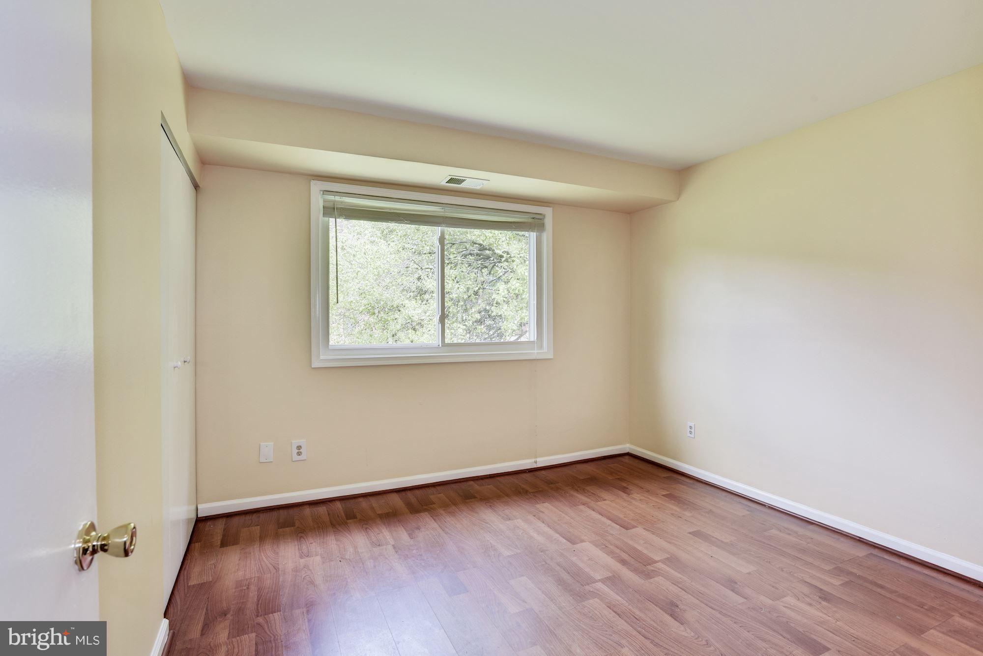 12009 Tarragon Road, Unit F Reisterstown, MD 21136 - Photo 14 of 22 an empty room with wooden floor and windows