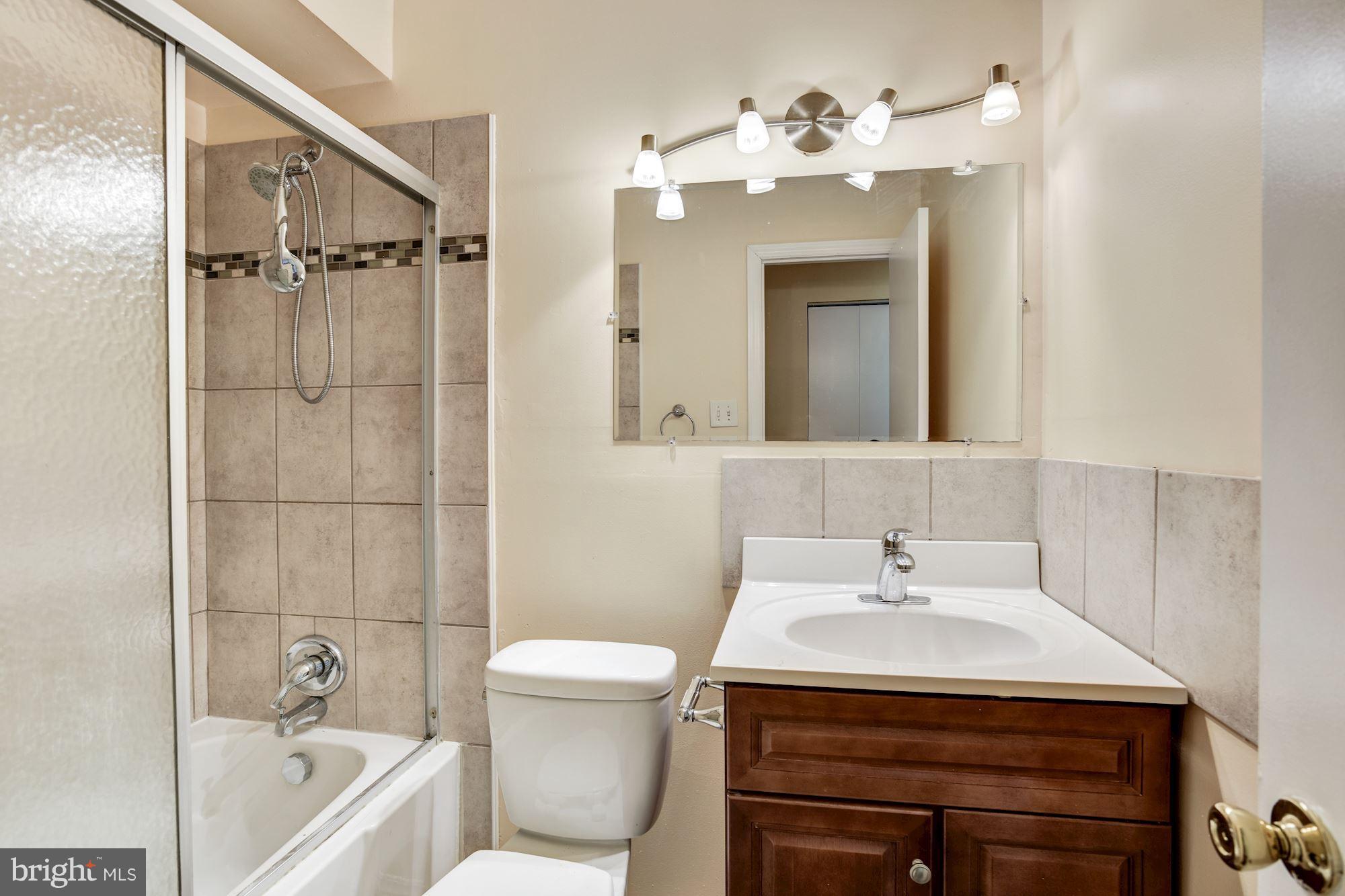 12009 Tarragon Road, Unit F Reisterstown, MD 21136 - Photo 15 of 22 a bathroom with a sink a toilet and shower