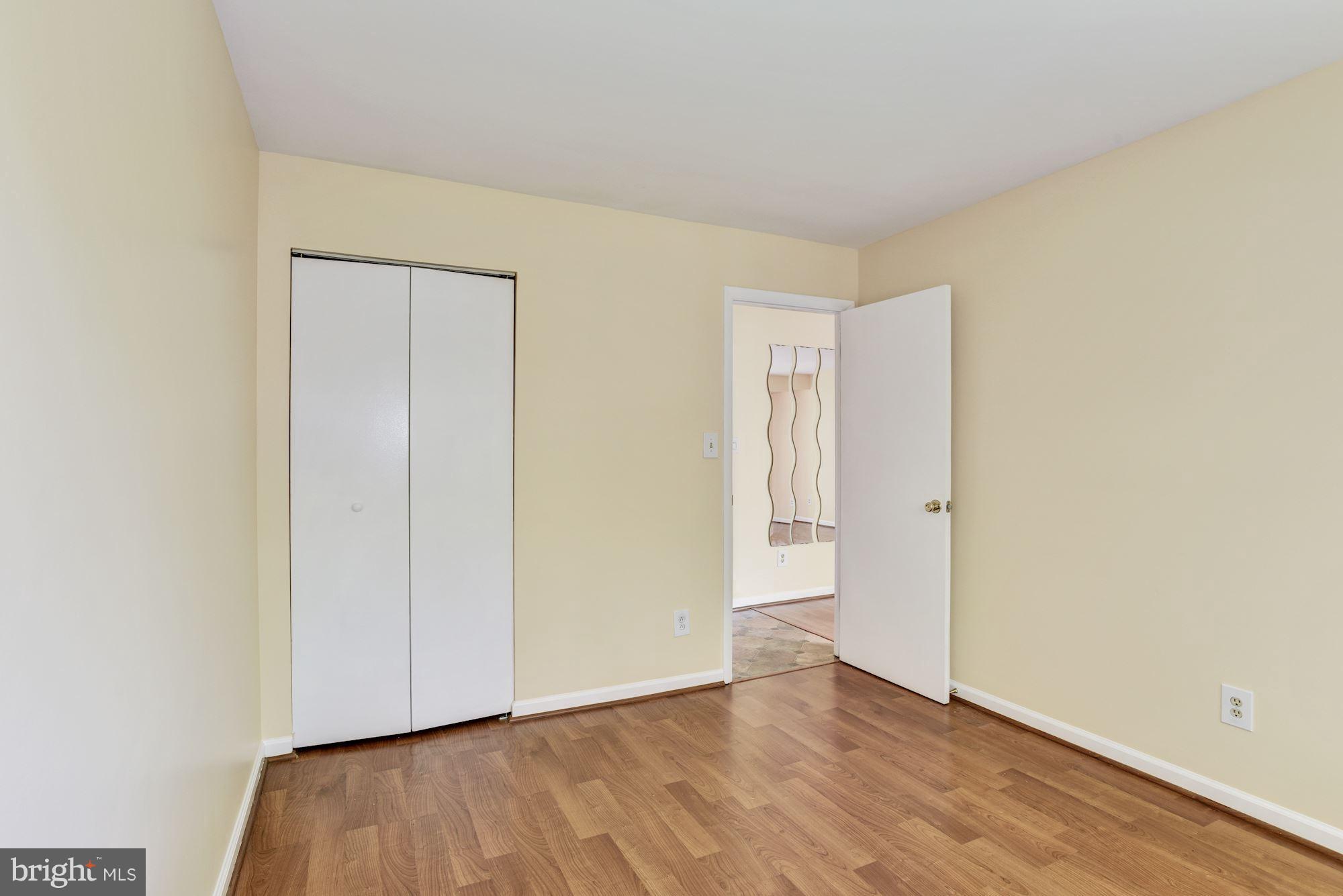12009 Tarragon Road, Unit F Reisterstown, MD 21136 - Photo 17 of 22 a view of an empty room and wooden floor
