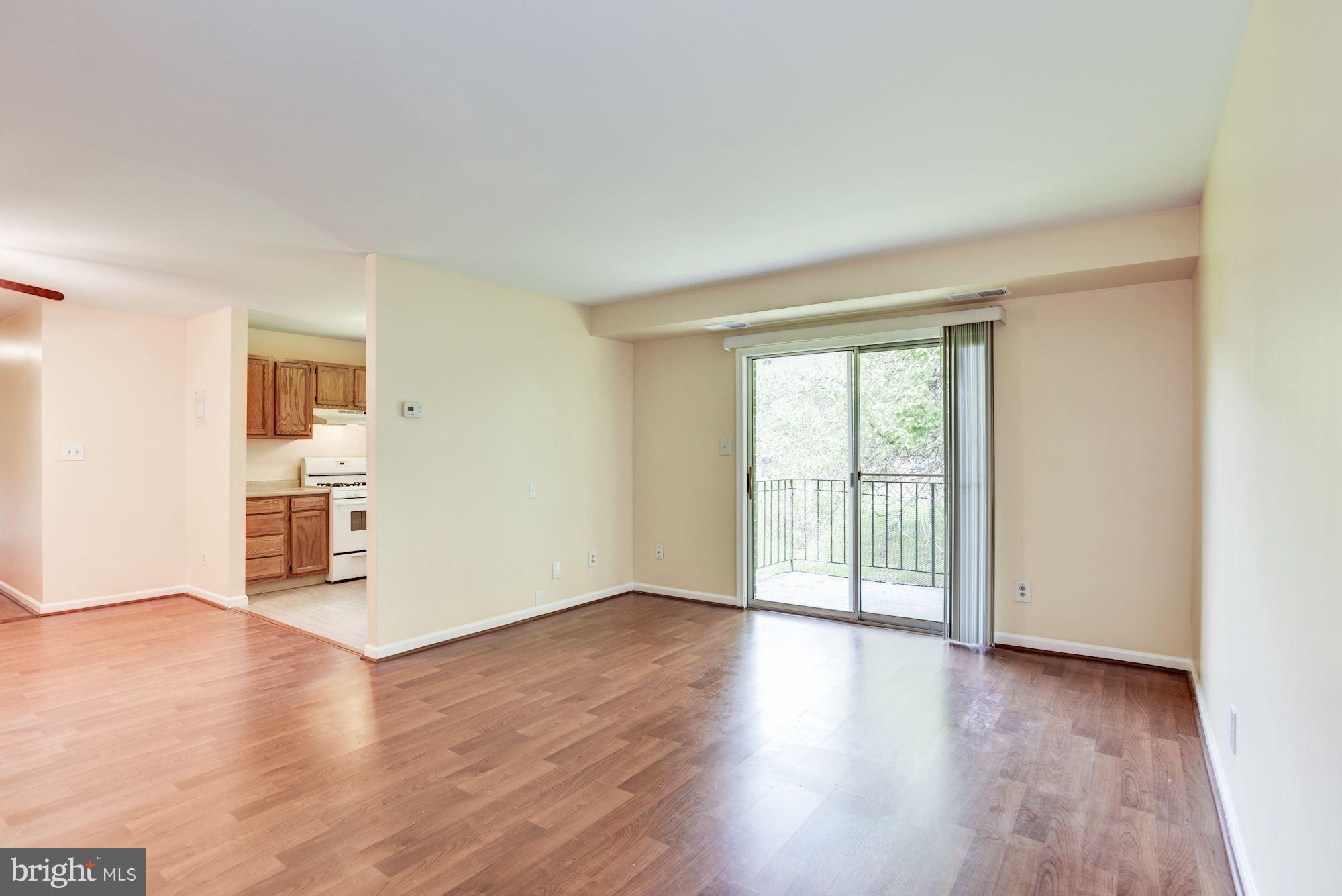 12009 Tarragon Road, Unit F Reisterstown, MD 21136 - Photo 3 of 22 a view of an empty room with wooden floor and a window