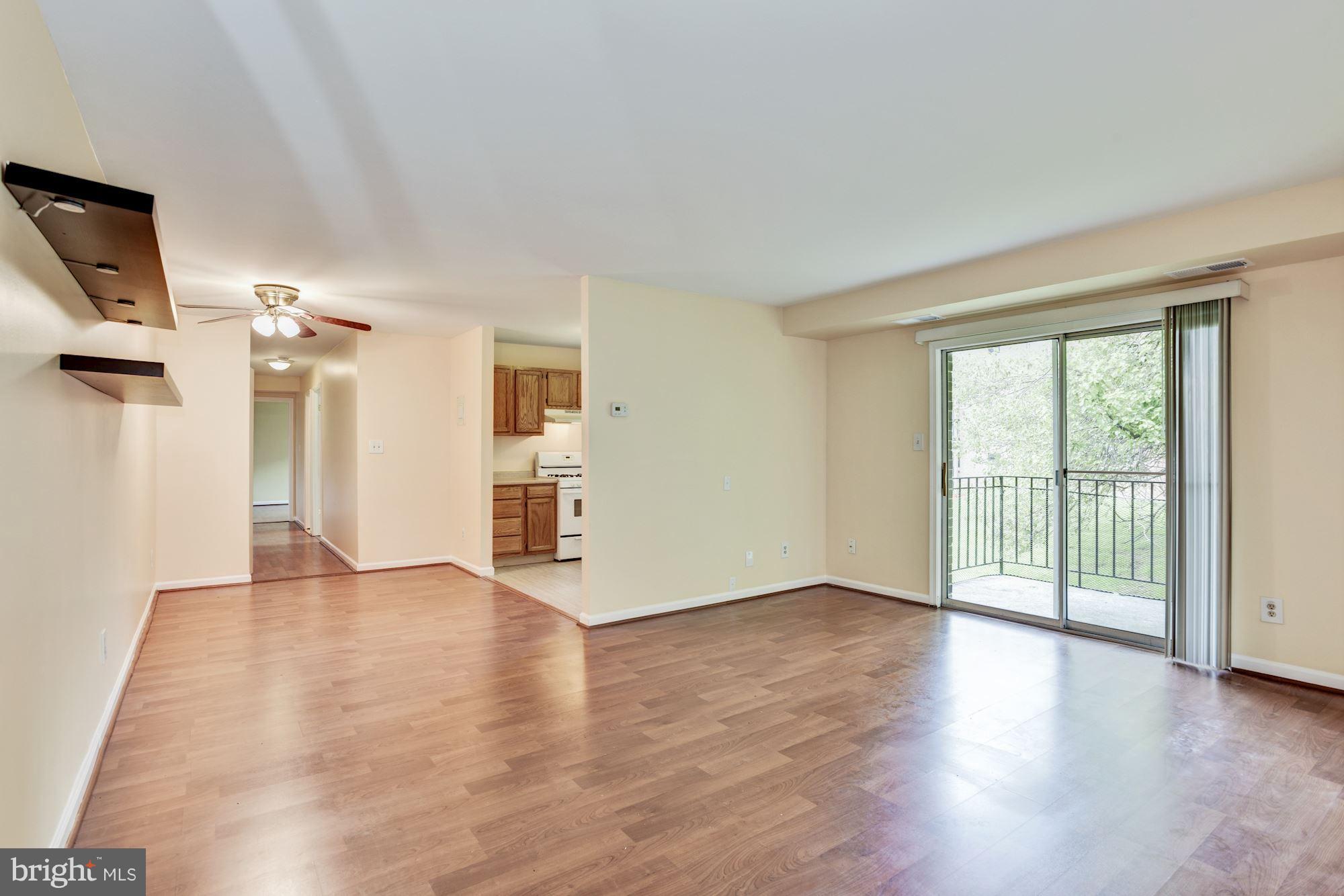 12009 Tarragon Road, Unit F Reisterstown, MD 21136 - Photo 4 of 22 an empty room with wooden floor and windows