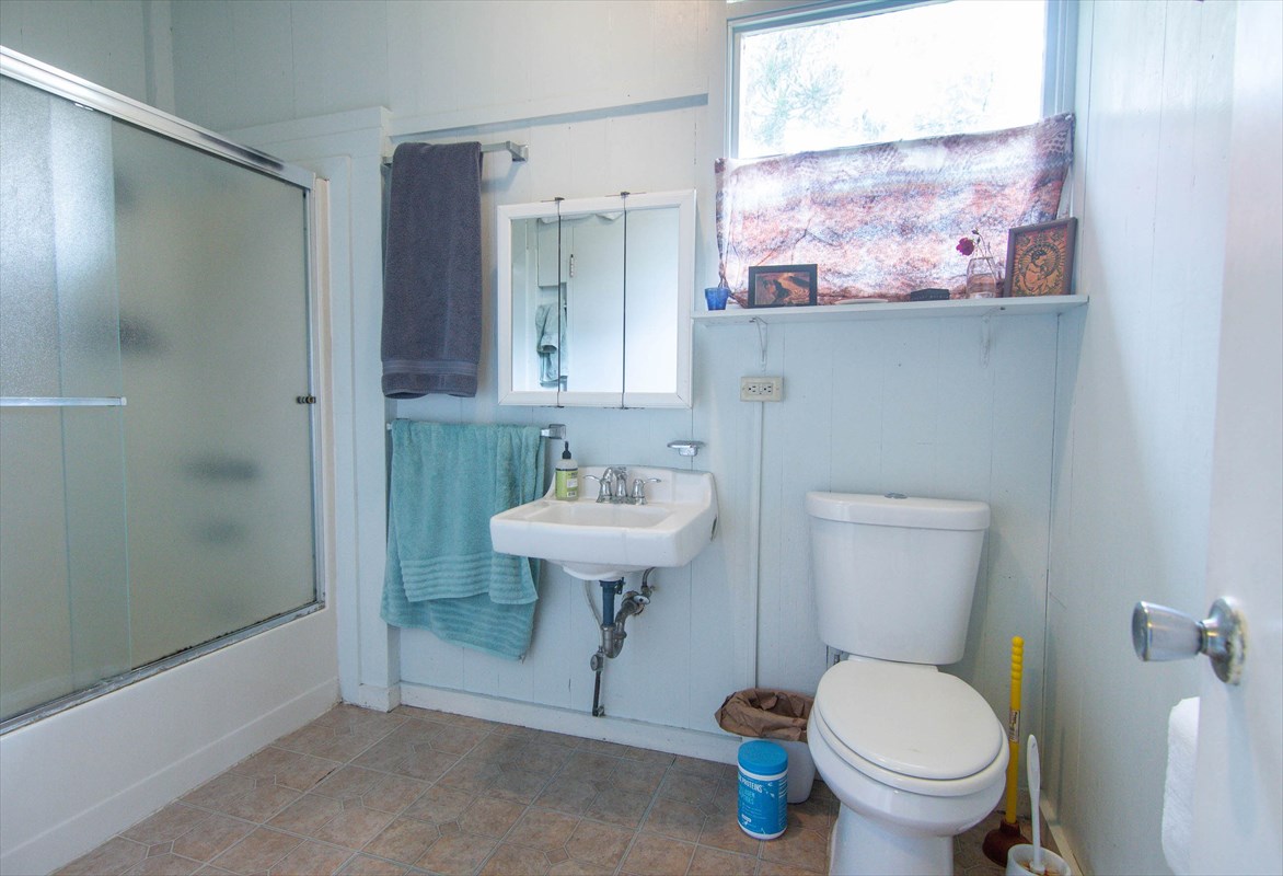 82-1135 Kinue Road Captain Cook, HI 96704 - Photo 23 of 30 a bathroom with a toilet sink and mirror