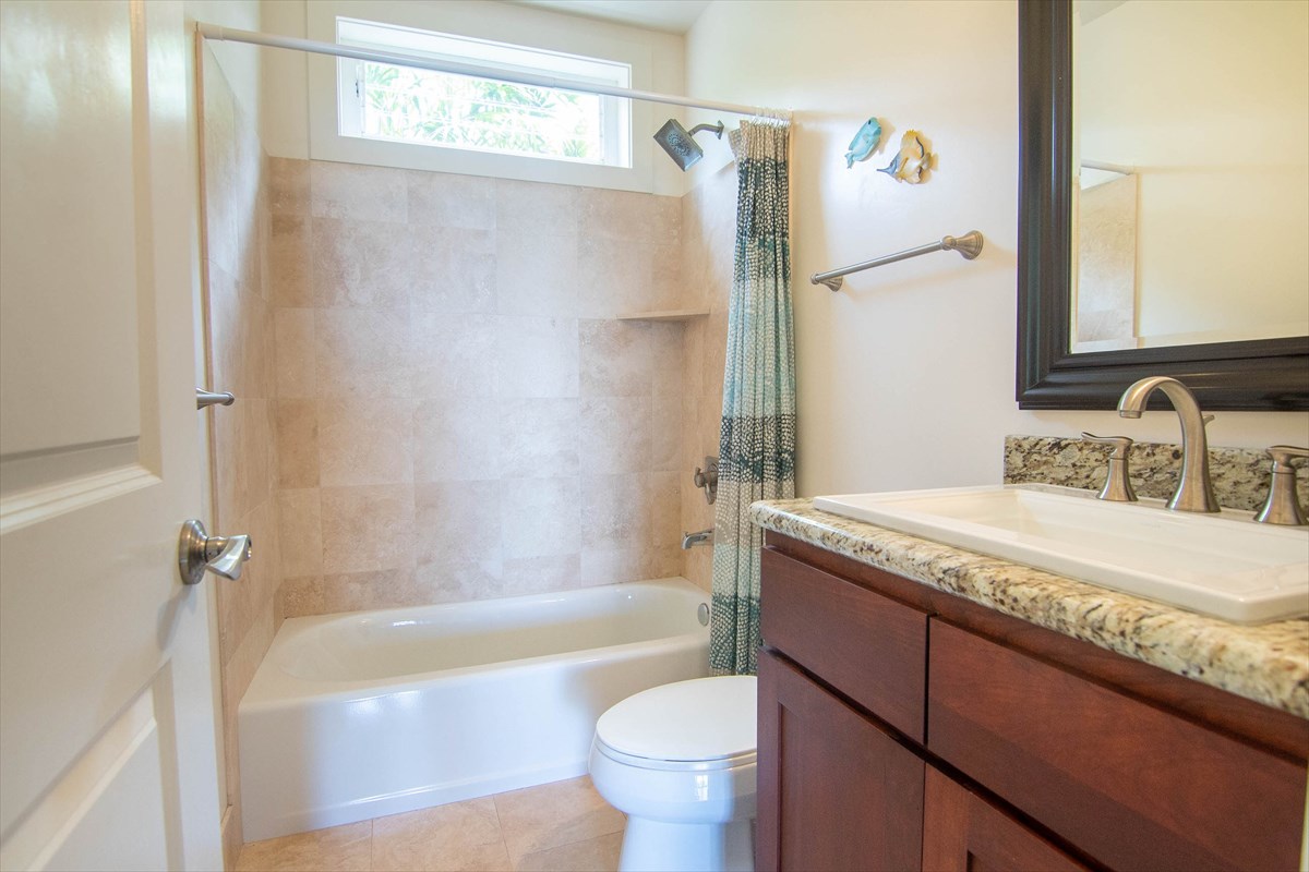 82-1135 Kinue Road Captain Cook, HI 96704 - Photo 28 of 30 a bathroom with a granite countertop sink toilet and shower